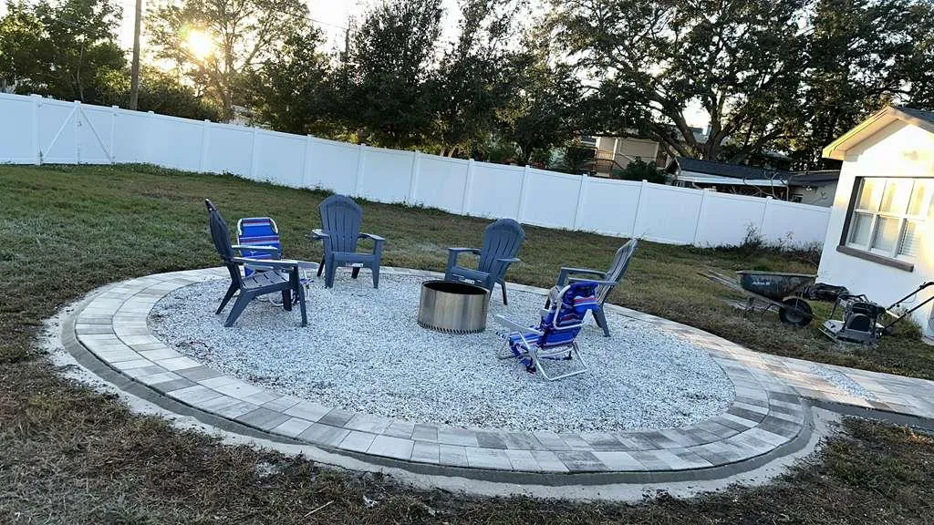 Gray paver patio installed beside a screened porch