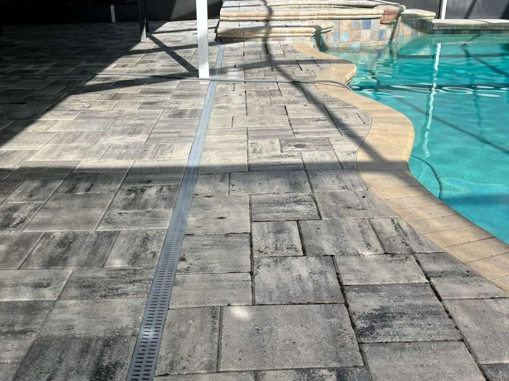 Paver pool deck with spa and mosaic tile detail